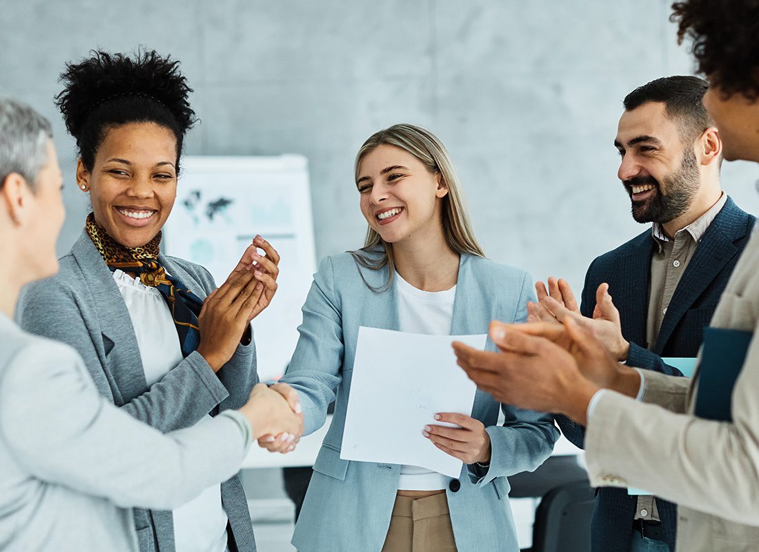 About Our Agency - Group of Business Professionals Clapping After a Successful Meeting