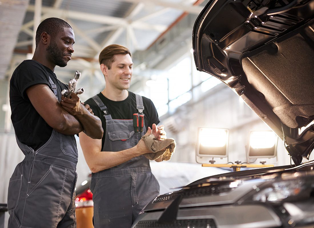 Business Insurance - Two Auto Technicians Inspect a Car at an Auto Shop